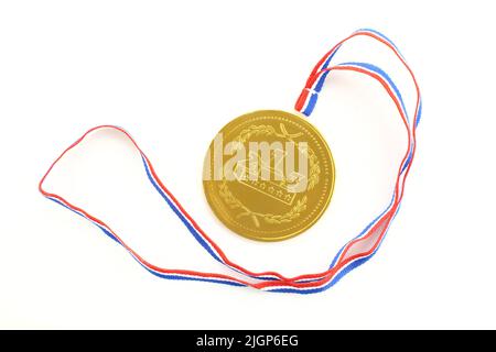 Golden medal prize and colorful ribbon. Round medallion isolated on white background Stock Photo