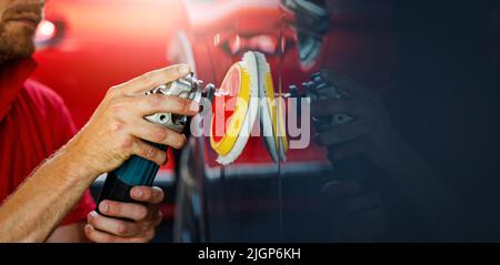car body repair and detailing workshop. man polishing vehicle paint. copy space Stock Photo