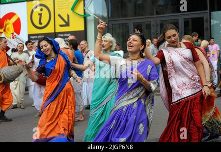 Cheerful people in Indian clothes, Hare Krishna adherents, singing and playing drums on the street. May 19, 2019. Kyiv, Ukraine Stock Photo