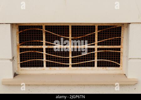 Rusty old window on the side of a building Stock Photo