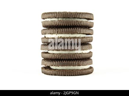 Stack of vanilla milky cream filled sandwich cookies isolated on white background Stock Photo