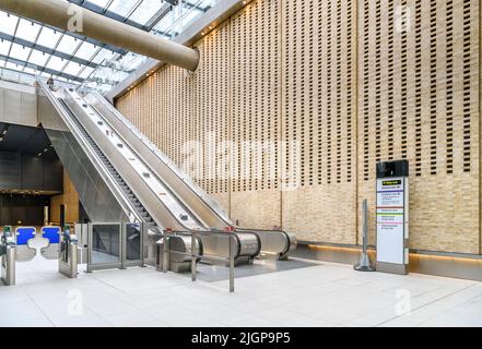 Entrance hall of Paddington station on the new Elizabeth Line underground in London. With a dramatic wall of punched brickwork. Stock Photo