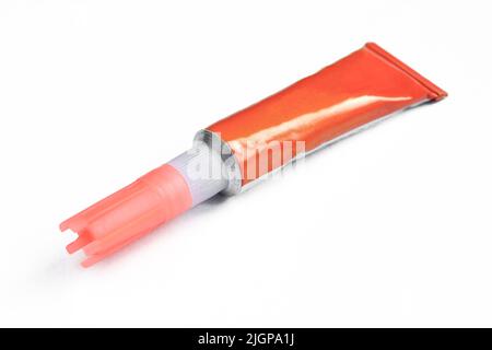 Red super glue tube isolated on white background. Blank package Stock Photo