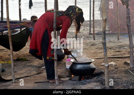 July 11, 2022, Lahore, Punjab, Pakistan: Pakistani gypsy spread salted meat for drying on a charpai collected from different places during the 2nd day of the Muslims Eid al-Adha celebration or Festival of Sacrifice in Lahore. Muslims celebrate Eid al-Adha or Feast of Sacrifice, the second of two Islamic holidays celebrated worldwide marking the end of the annual pilgrimage or Hajj to the Saudi holy city of Mecca and commemorating the willingness of the Prophet Ibrahim, Abraham to Christians and Jews, to sacrifice his son. During the holiday, which in most places lasts four days, Muslims Slaugh Stock Photo