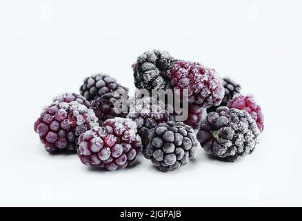 Group of frozen blackberries isolated on white background. Chilled fruit Stock Photo