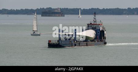 Portsmouth southern England UK. 2022. Wind turbine blade as cargo on Blade runner two  ship underway crossing The Solent bound for Portsmouth Harbour. Stock Photo