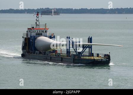 Portsmouth southern England UK. 2022. Wind turbine blade as cargo on Blade runner two  ship underway crossing The Solent bound for Portsmouth Harbour. Stock Photo