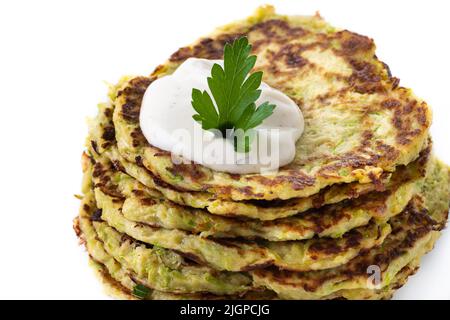 Zucchini fritters with yogurt sauce isolated on white background Stock Photo