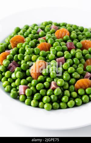 Green peas with serrano ham and carrot isolated on white background Stock Photo