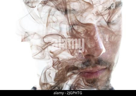 A portrait of a young man combined with an image of smoke Stock Photo