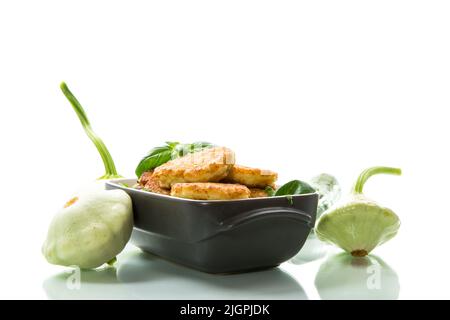 fried vegetable pancakes from squash and zucchini with greens, isolated on a white background. Stock Photo