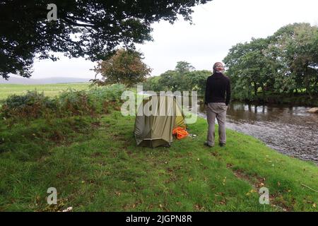 Solo Hiker wild camping in the Vango F10 Helium UL 1 Person Tent. Arran Coastal Way. Isle of Arran. North Ayrshire. Scotland. UK Stock Photo