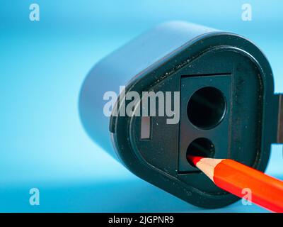 Education and back to school concept. Pencil and sharpener on a blue background. Stock Photo