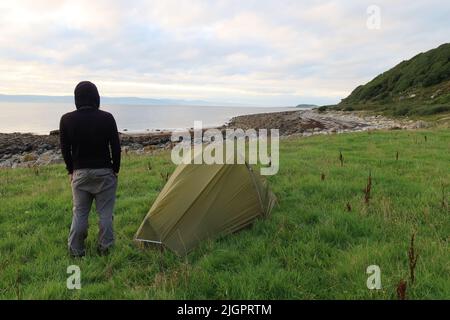 Solo Hiker wild camping in the Vango F10 Helium UL 1 Person Tent. Arran Coastal Way. Isle of Arran. North Ayrshire. Scotland. UK Stock Photo