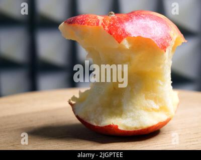 A bitten red apple, close-up shot. Apple core. Stock Photo