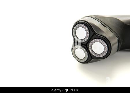 Close up of grey electric razor that lays sideways. Male electric rotary shaver isolated on white background.  Stock Photo