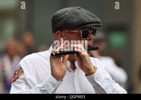 Members of Shankill Old Boys Flute Band take part in a Twelfth of July parade in Belfast, as part of the traditional Twelfth commemorations marking the anniversary of the Protestant King William's victory over the Catholic King James at the Battle of the Boyne in 1690. Picture date: Tuesday July 12, 2022. Stock Photo