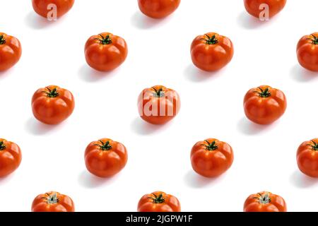 Seamless pattern with red fresh tomatoes on a white background with hard light and shadow. Healthy lifestyle concept and vegetarianism Stock Photo
