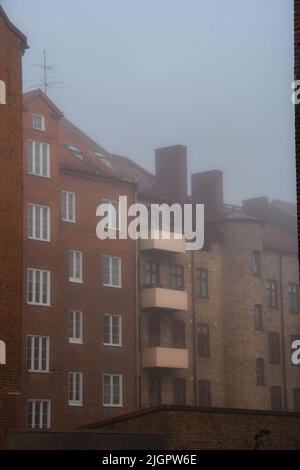 Photo of houses or apartments in a city or town while foggy weather Stock Photo