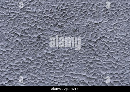 Gray texture of concrete wall of an old house. Decorative textured plaster, outside surface finish of home. Abstract background with construction concept. Stock Photo