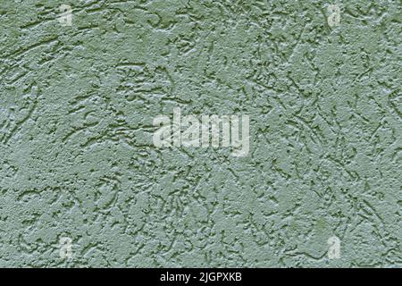 Beautiful light green texture of concrete wall of the house. Abstract rough background for a construction project. Decorative textured plaster, outside surface finish. Stock Photo