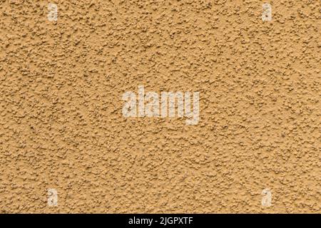Orange textured concrete wall. Decorative plaster of the house. Abstract orange background. Stylish decorative surface finish.  Stock Photo