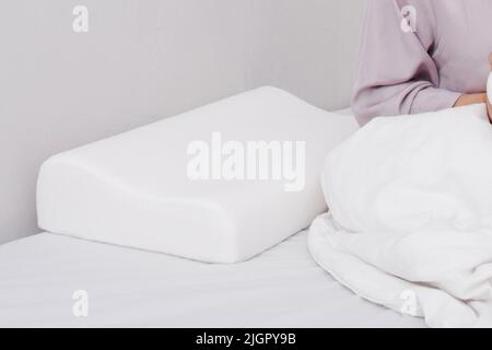 Orthopedic Pillow with a Memory Effect. Medical treatment pillow for sleep. Comfort Memory Pillow under the head with a recess under the shoulder Stock Photo