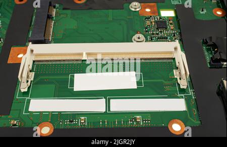 electrical circuit from a laptop, with a connector for RAM, close-up Stock Photo