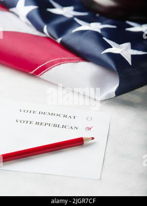 Election campaign. Vote for Democrats and Republicans. parliamentary elections. American flag and piece of paper, red pencil. Elections, voting. Banne Stock Photo