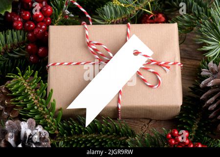 Christmas rectangle strip gift tag mockup with present box, product label mockup, with natural fir tree branch, cones and Christmas decoration, Christ Stock Photo