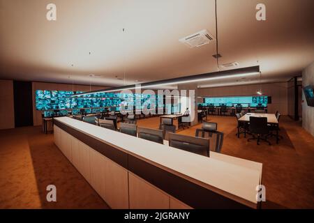 Empty interior of big modern security system control room, workstation with multiple displays, monitoring room with at security data center Empty Stock Photo