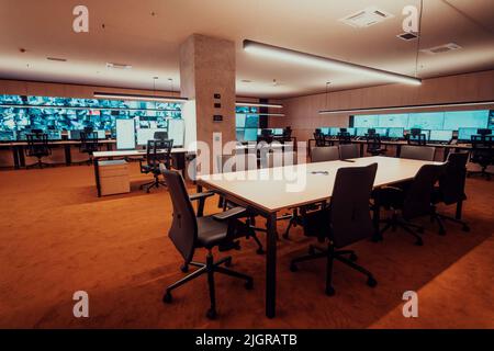 Empty interior of big modern security system control room, workstation with multiple displays, monitoring room with at security data center Empty Stock Photo