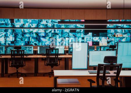 Empty interior of big modern security system control room, workstation with multiple displays, monitoring room with at security data center Empty Stock Photo
