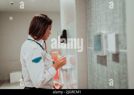 Photo of a woman who works for a bank or a security service opening a safe for money Stock Photo