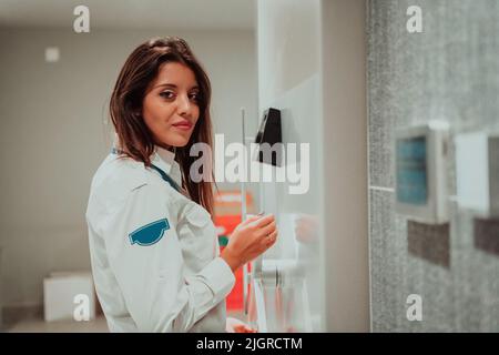 Photo of a woman who works for a bank or a security service opening a safe for money Stock Photo
