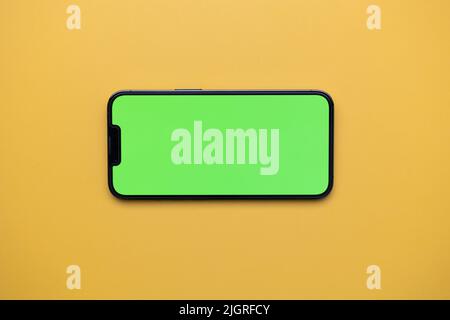 Smartphone with green screen. Template with phone and green screen. Black Smartphone with Greenscreen. Stock Photo