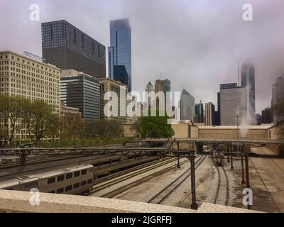 Chicago skyline and a rail yard with a fog rolling in covering the tops of the buildings in the early morning Stock Photo