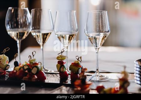 Champagne glasses on the background of snacks on the table on the white background. High quality photo Stock Photo