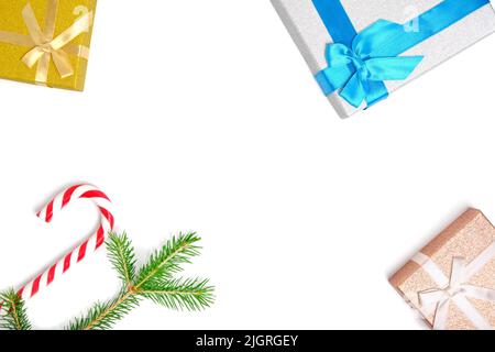 Christmas gift boxes and caramel form of a cane on white background Stock Photo