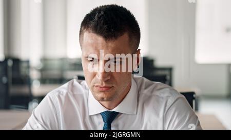 A portrait of a caucasian manager at workplace wearing white shirt and tie Stock Photo