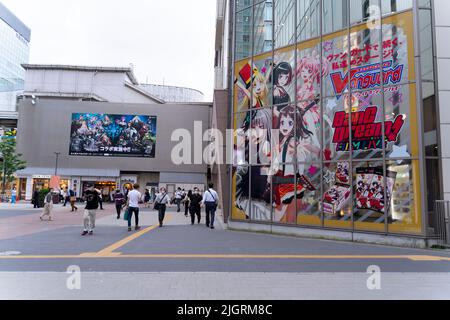 Akihabara, Japan- July 30, 2020: People walk past a giant anime billboard in Akihabara. Stock Photo