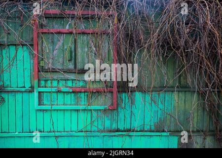 Part of an old wooden wall with closed window Stock Photo