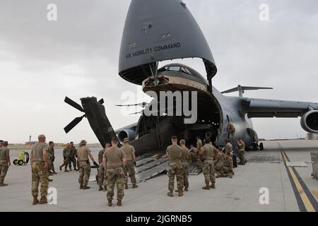 The 1st Attack Reconnaissance Battalion, 211th Aviation Regiment, Utah National Guard, load four AH-64D Apache helicopters onboard a C-5 Galaxy, to be transported to Morocco in support of African Lion 22, a U.S. Africa Command annual exercise on Saturday, June 18, 2022.     The 1-211th ARB aircraft maintaniners prepped the aircraft for loading onto the C-5 by folding the blades and then members of the 151st Air Refueling Wing, Utah Air National Guard, assisted in loading and securing the helicopters on the C-5 from Travis Air Force Base, California, for transportation to Morocco. Stock Photo