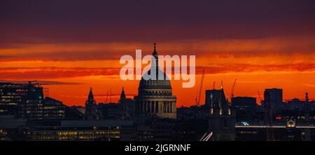 London, UK. 12th July, 2022. UK Weather: Heatwave colourful sunset behind St. Paul's Cathedral. Temperatures in the UK - already hitting 32C so far this week - are expected to rise further and could reach 40C for the first time ever. Credit: Guy Corbishley/Alamy Live News Stock Photo