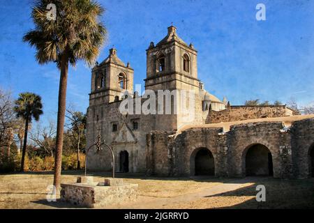 Mission Concepcion, San Antonio, Texas: This is a textured photograph of an old Spanish stone mission, with blue skies, arches, and a well.. Stock Photo