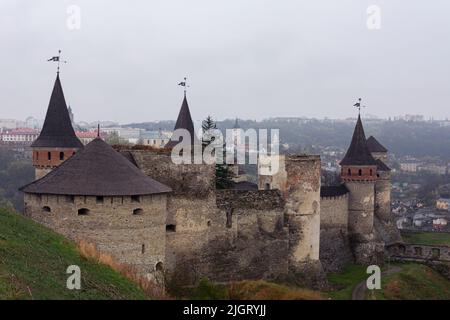 Ancient stone fortress in the Ukrainian city of Kamenets Podolsky. Photo of an antique fortification architectural monument on a cloudy day. Medieval Stock Photo