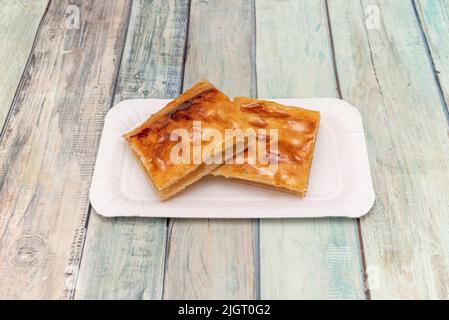 Rectangular pastry made from puff pastry with maple syrup and pecan ...