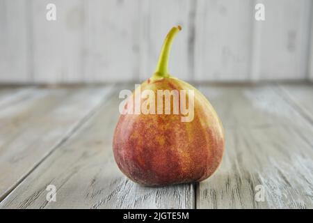 Fresh figs alone on wooden background, selective focus Stock Photo