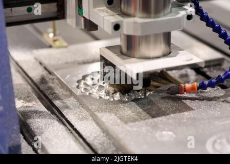 Die and mold making with CNC milling machine. Selective focus. Stock Photo