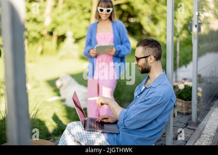 Couple work on laptop computer on nature Stock Photo